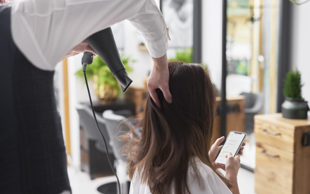 close-up-of-hairdresser-using-hair-dryer